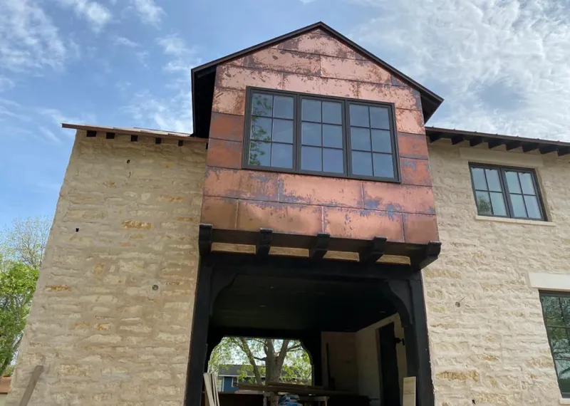 Copper metal panel facade on a stone building for Skylight Installation in Knik-Fairview